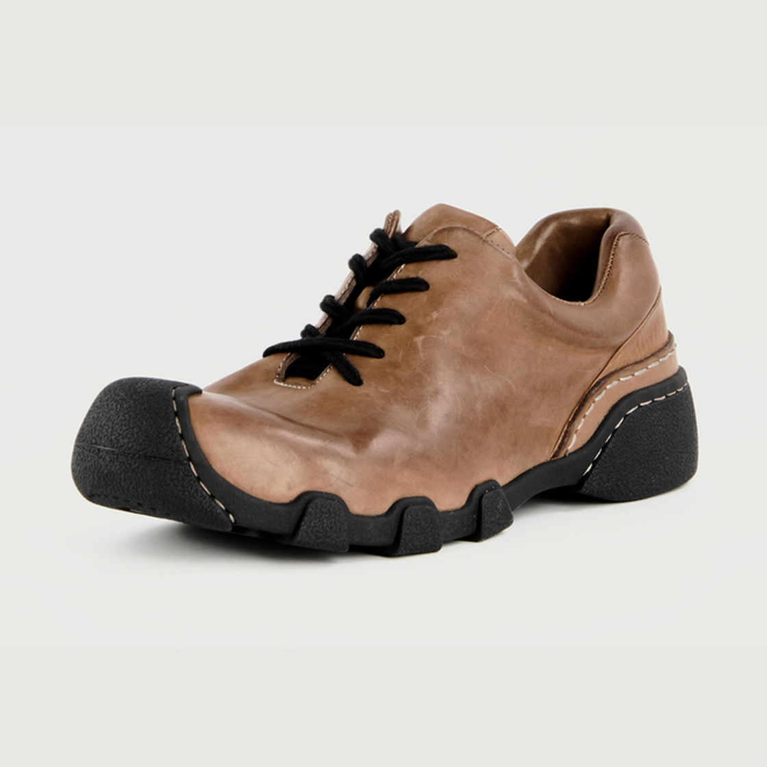 Brown washed horsehide urban trail shoe on a light gray background
