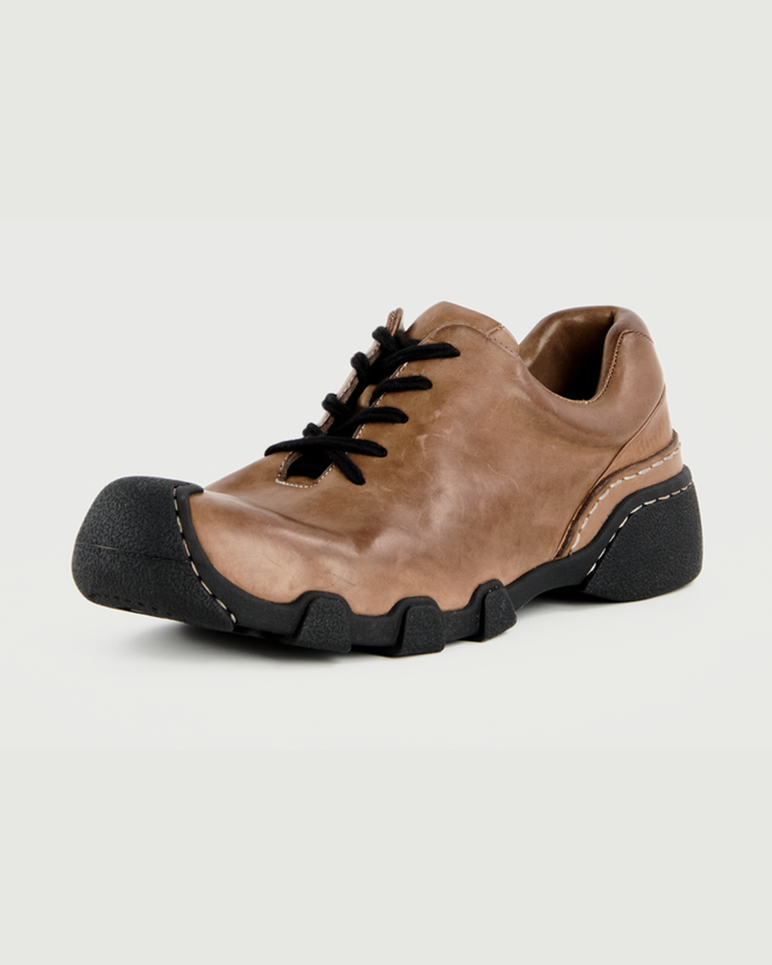 Brown washed horsehide urban trail shoe on a light gray background